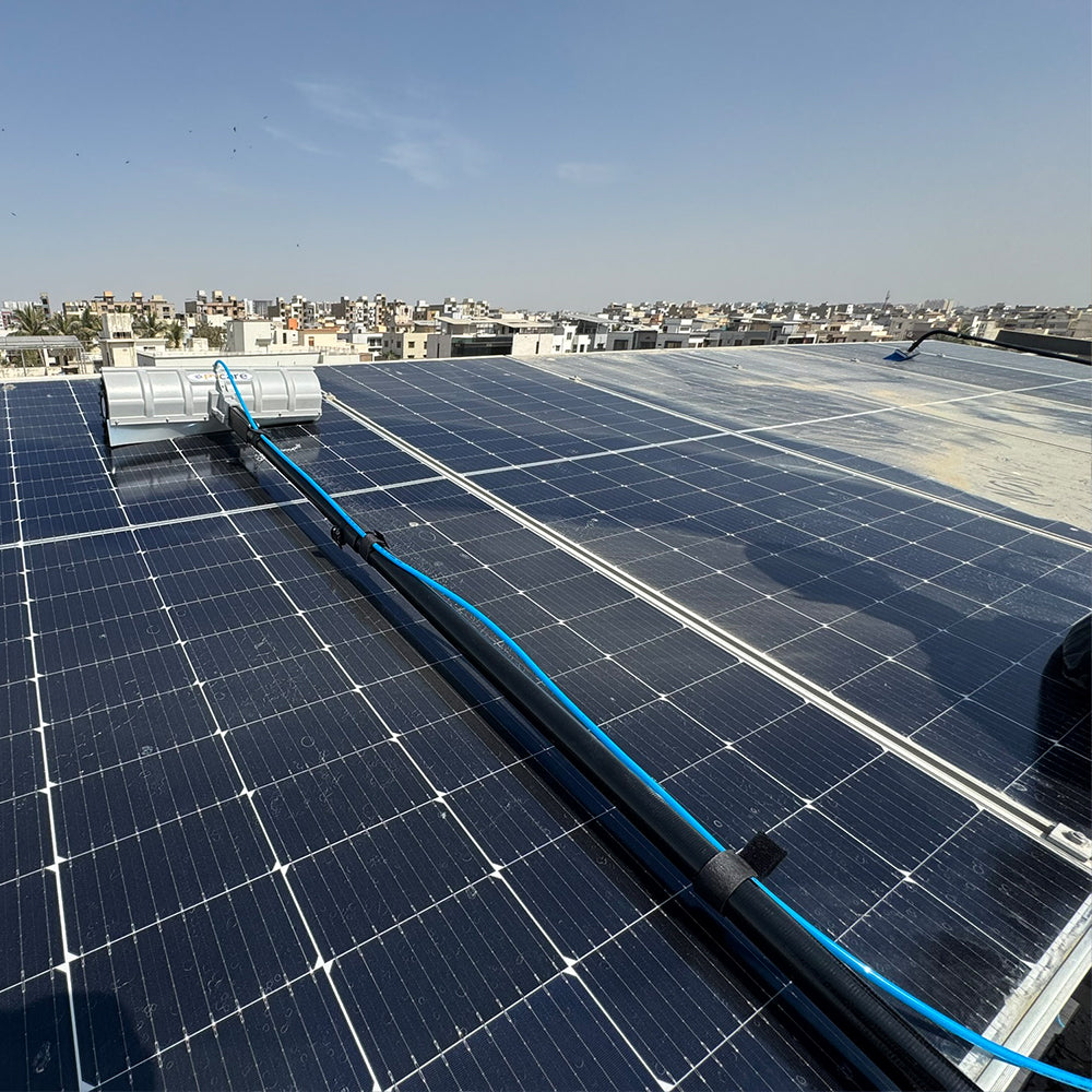 PVCare solar cleaning robot moving across a solar panel, brushing away dust for improved efficiency