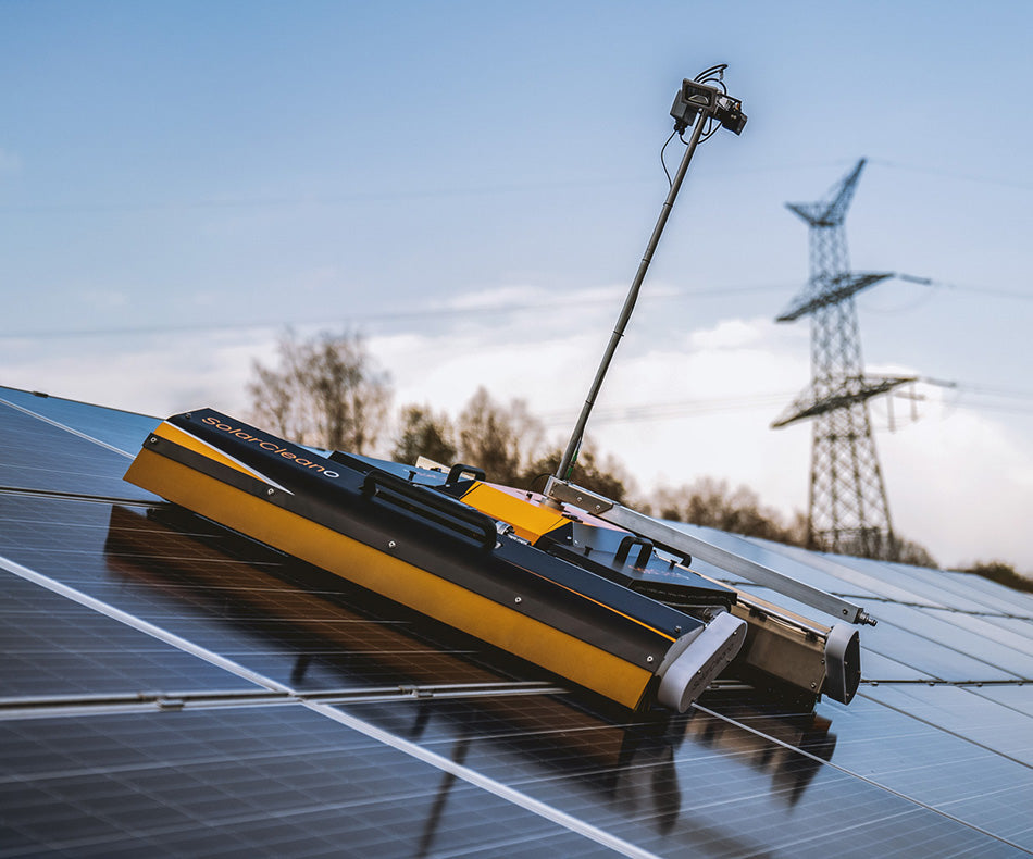 PV Care F1 solar cleaning robot actively moving across a solar panel, cleaning its surface.